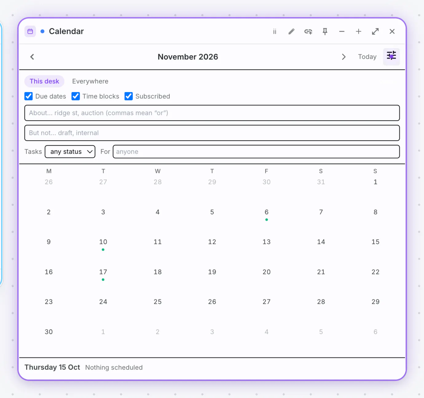 A calendar widget sitting on a desk beside the work